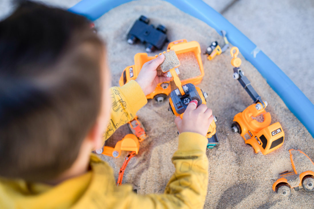 Major Martino plays in the sand table at his 3rd birthday party