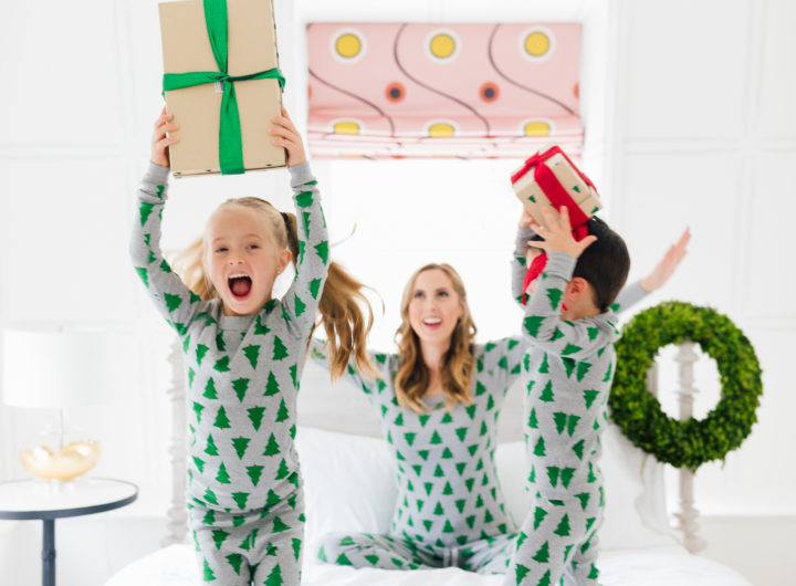 Eva Amurri Martino and her kids Marlowe and Major wear matching holiday pajamas and hold wrapped gifts in bed