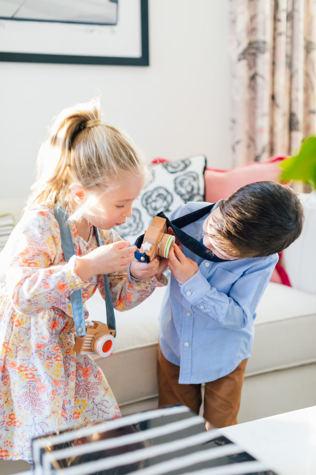 Marlowe and Major Martino play with a wooden toy from Verishop