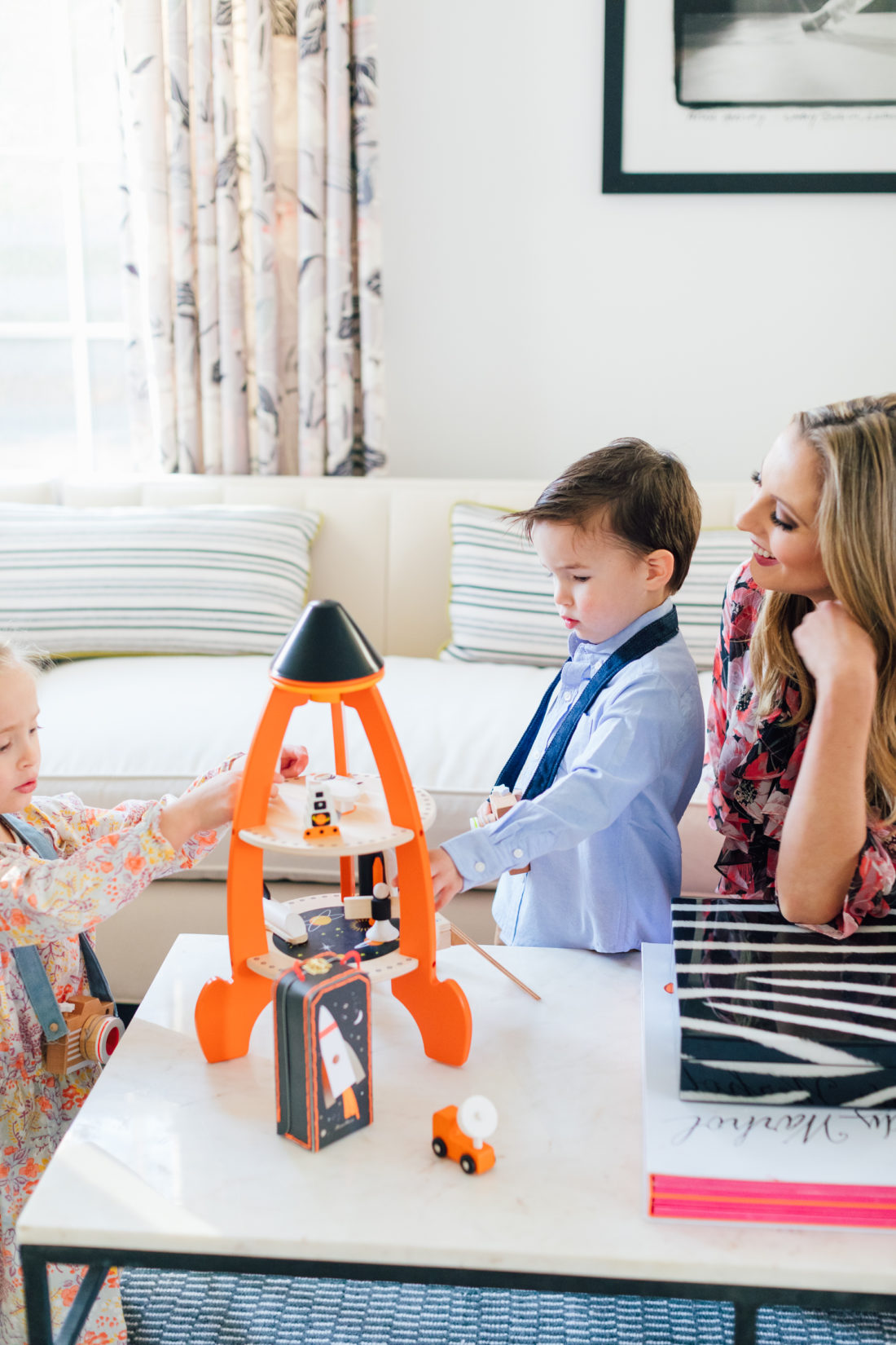 Marlowe and Major Martino play with a wooden toy from Verishop