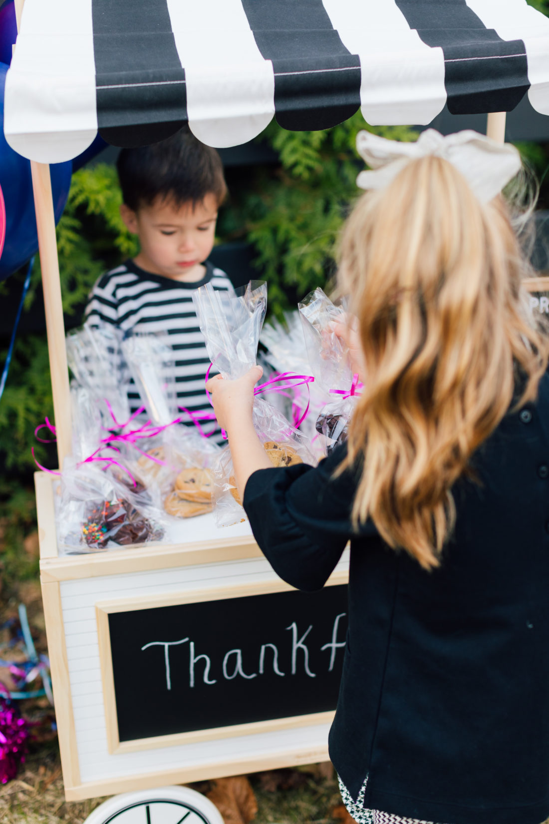 Eva Amurri Martino arranging baked goods at her bake sale benefitting nonprofit organization Filling in the Blanks