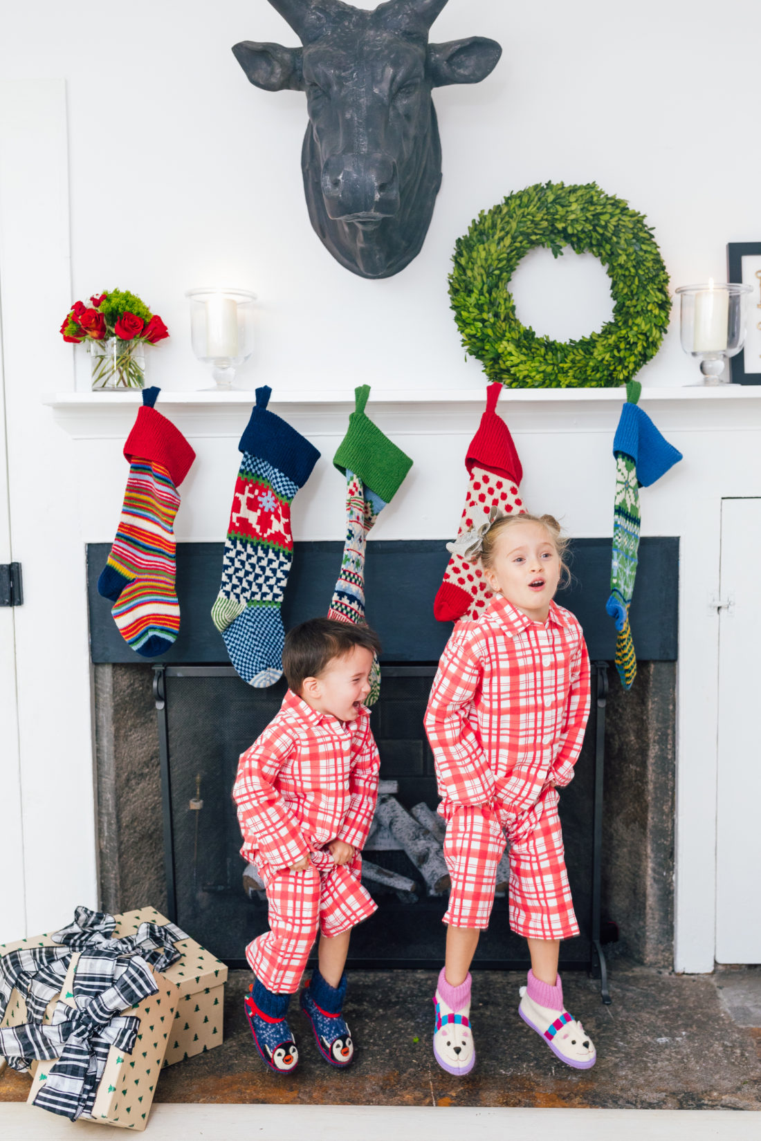 Marlowe and Major Martino show off their matching pajamas in front of their Christmas stockings, all from Garnet Hill