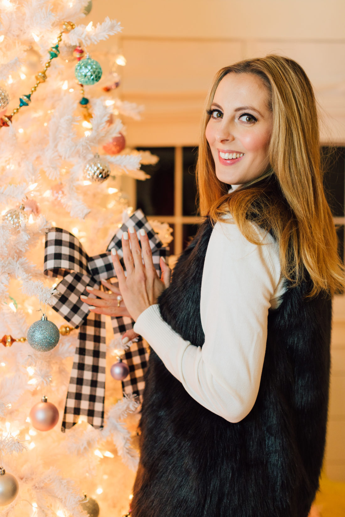 Eva Amurri poses by her Christmas Tree with some products bought at Walmart