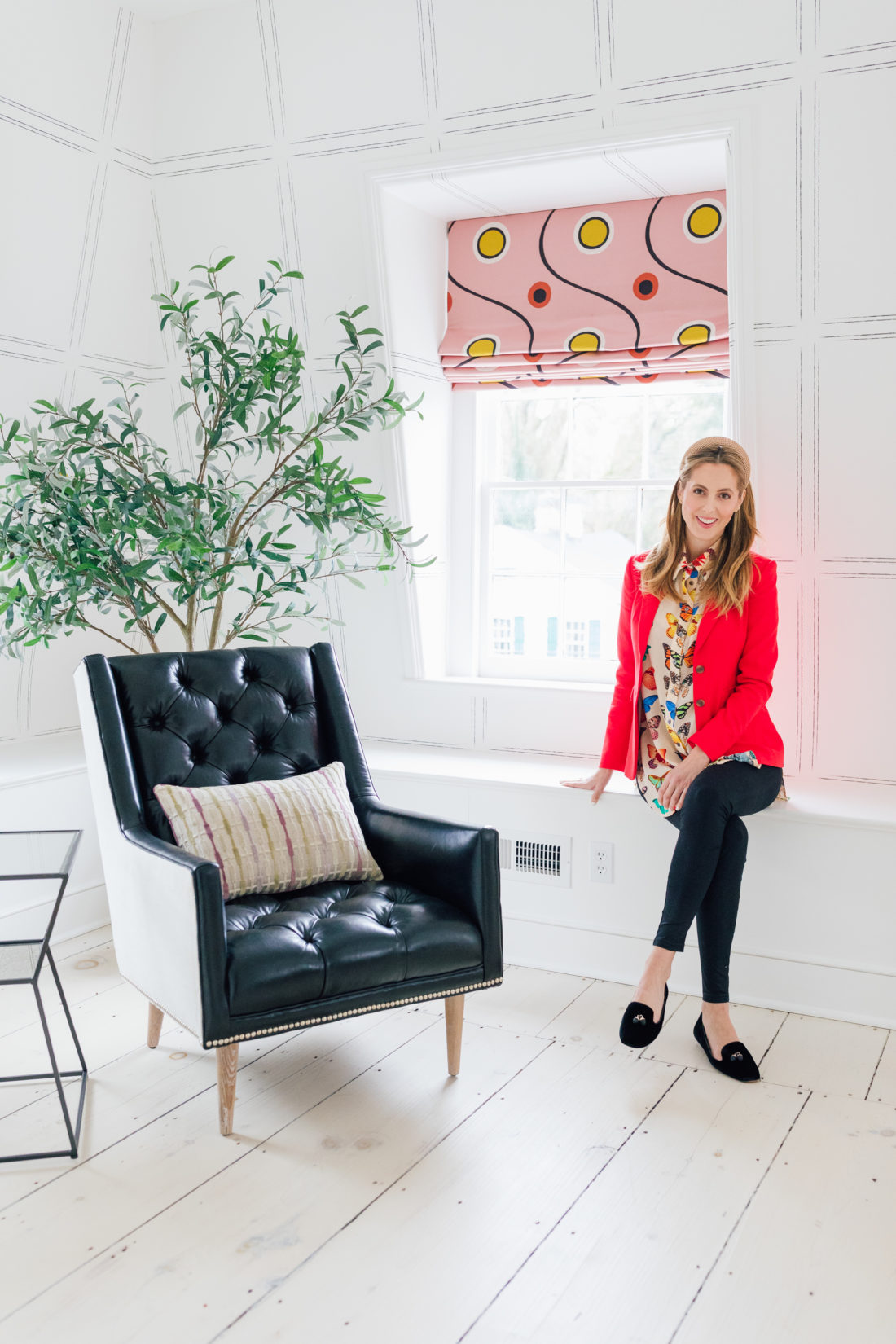 Eva Amurri sits next to a leather chair inside her newly finished Guest Suite