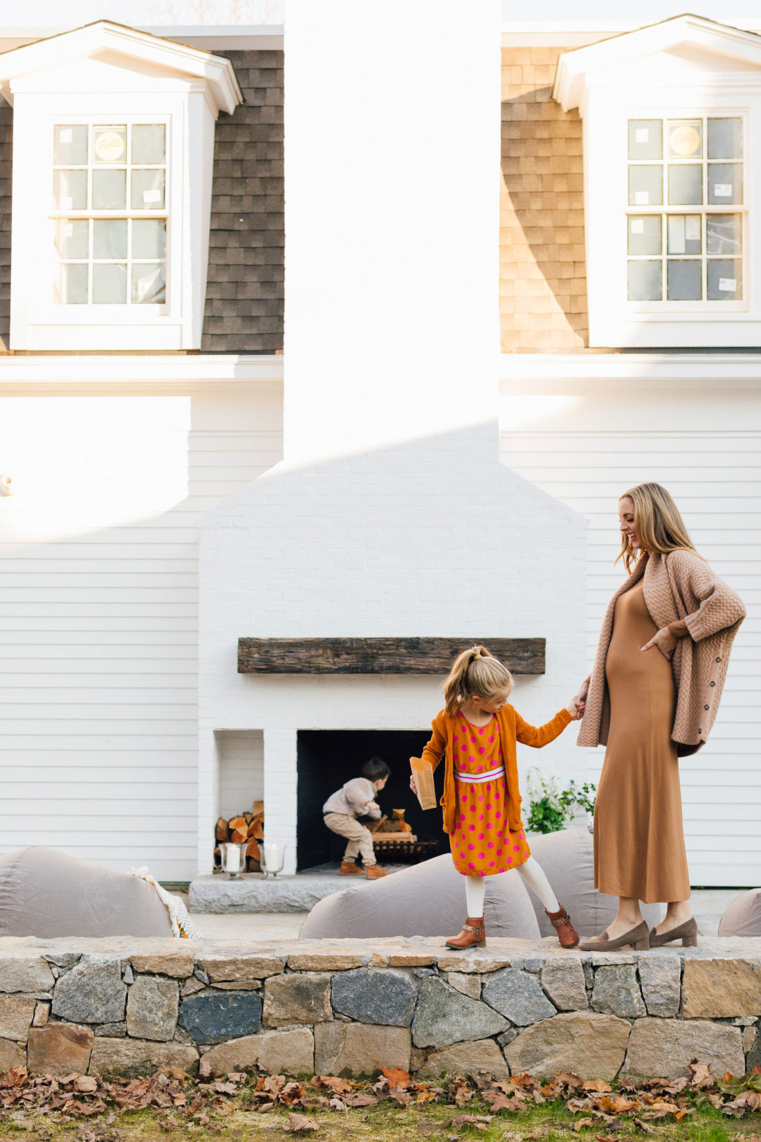 Marlowe Martino holds mom Eva Amurri's baby bump while brother Major tends to the fireplace