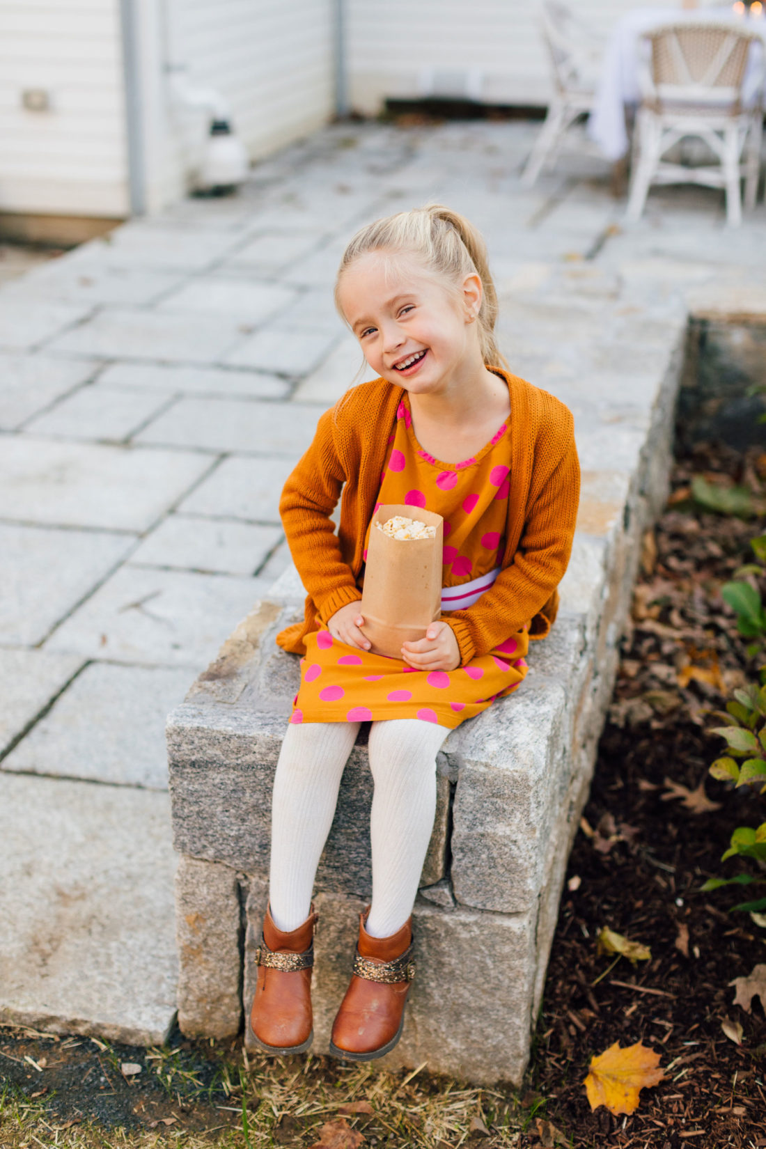 Marlowe Martino holds a bag of popcorn for an outdoor movie night on the back patio of her Connecticut home