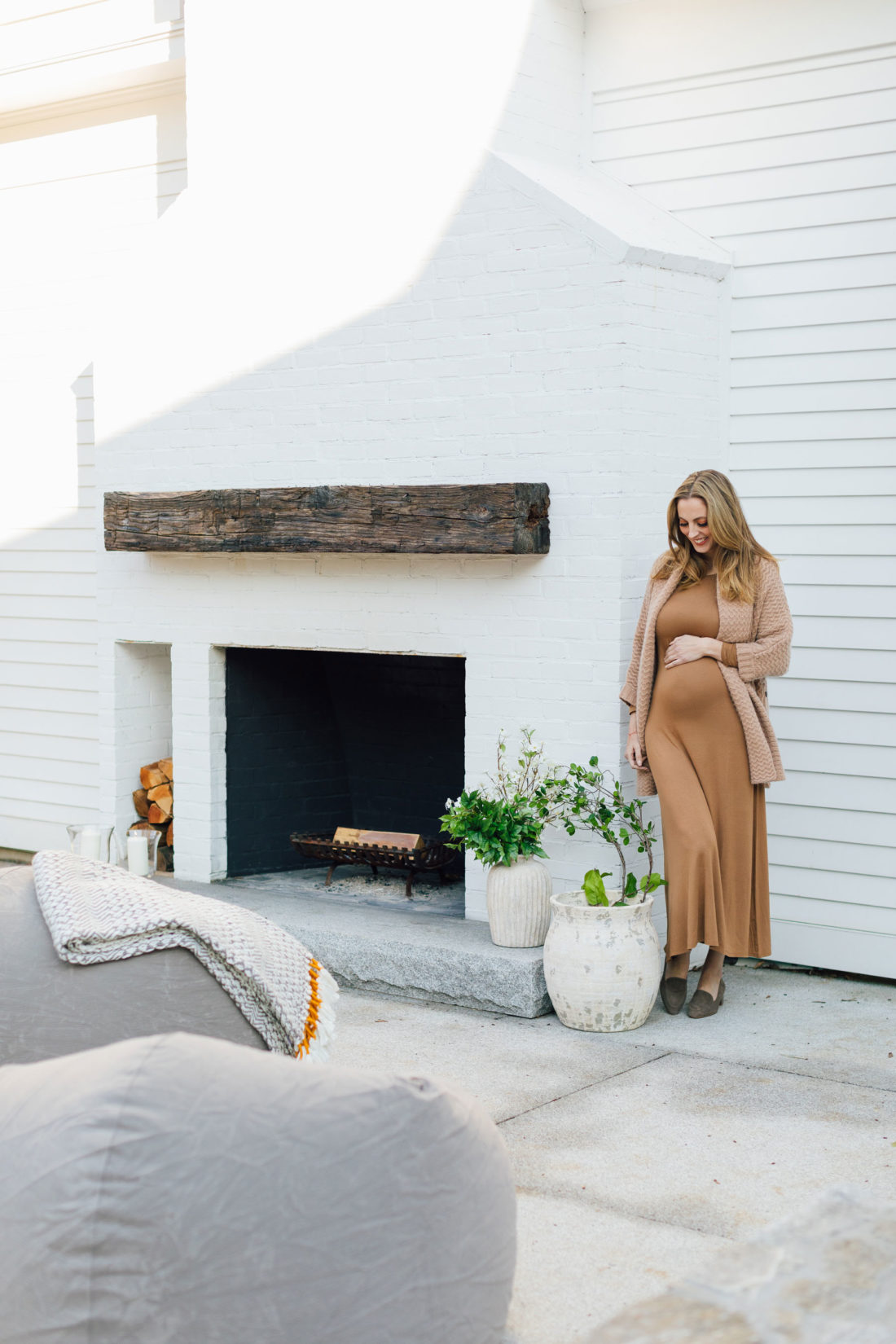 Eva Amurri cradles her baby bump on the back patio of her Connecticut home