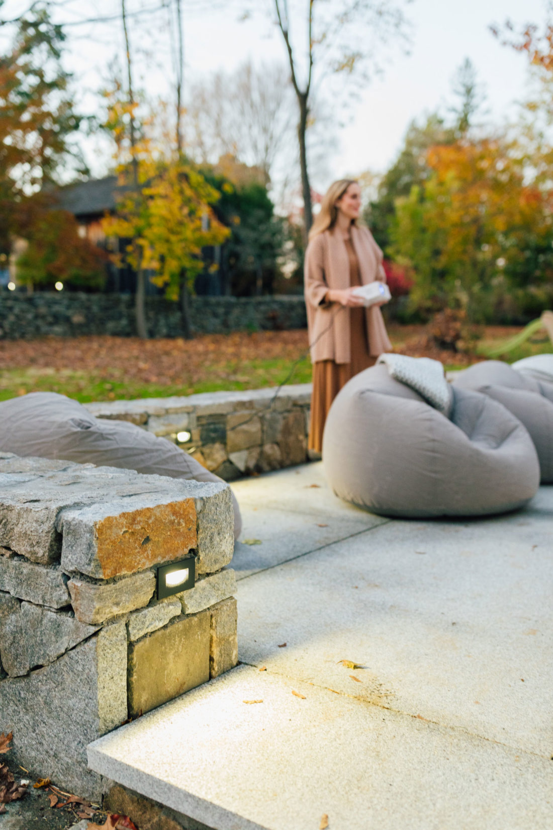 Eva Amurri holds a portable projector for an outdoor movie night on her back patio at her home in Connecticut