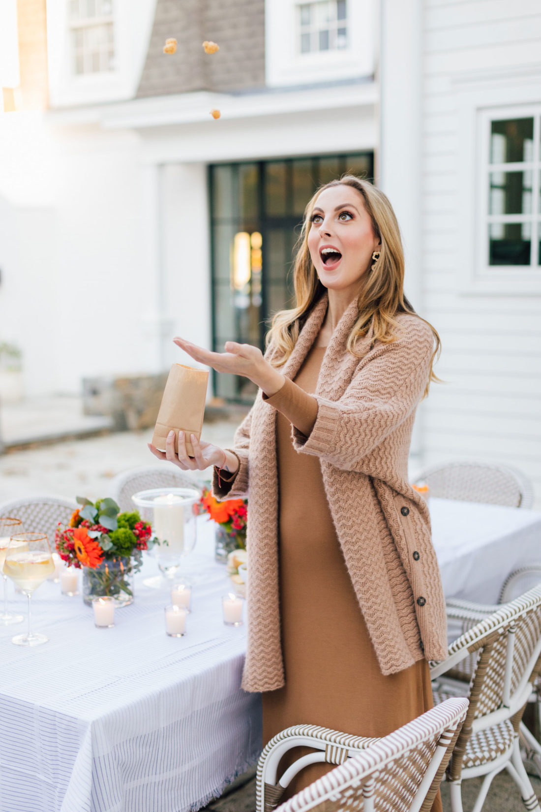 Eva Amurri throws popcorn into her mouth before an outdoor movie night on the back patio of her Connecticut home