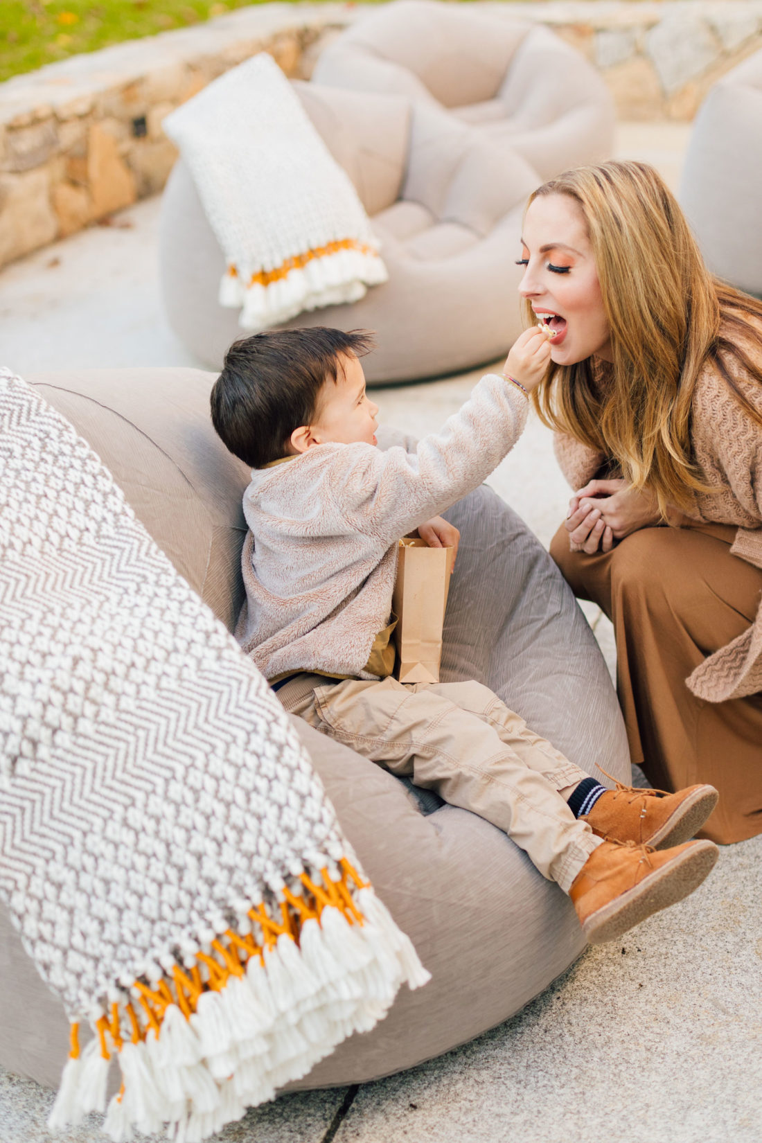 Eva Amurri gets fed popcorn by son Major at an outdoor movie night on the back patio of their Connecticut home